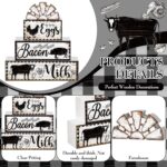 A set of four black and white wooden farmhouse signs, featuring a cow, rooster, and pig, displayed on a tiered tray.