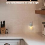 Two clear glass Mason jar night lights with brushed plastic bases, plugged into wall outlets, emitting a warm glow.