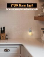 Two clear glass Mason jar night lights with brushed plastic bases, plugged into wall outlets, emitting a warm glow.