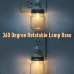 Two clear glass Mason jar night lights with brushed plastic bases, plugged into wall outlets, emitting a warm glow.