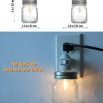 Two clear glass Mason jar night lights with brushed plastic bases, plugged into wall outlets, emitting a warm glow.