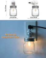 Two clear glass Mason jar night lights with brushed plastic bases, plugged into wall outlets, emitting a warm glow.