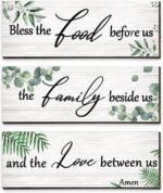 Three Maitys eucalyptus greenery wooden wall signs with 'Bless Family Food Love' text, hung on a rustic wall.