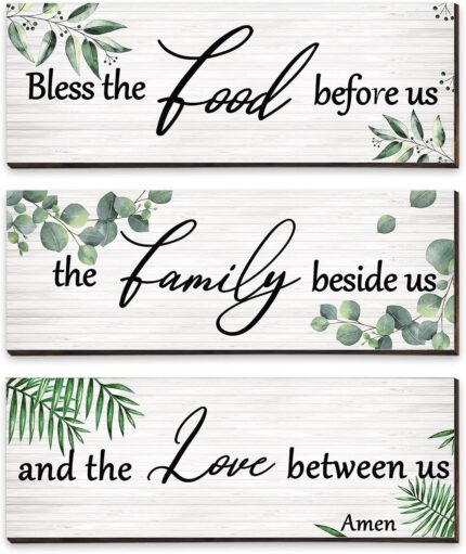 Three Maitys eucalyptus greenery wooden wall signs with 'Bless Family Food Love' text, hung on a rustic wall.