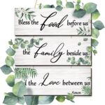 Three Maitys eucalyptus greenery wooden wall signs with 'Bless Family Food Love' text, hung on a rustic wall.