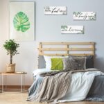 Three Maitys eucalyptus greenery wooden wall signs with 'Bless Family Food Love' text, hung on a rustic wall.
