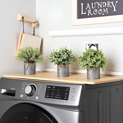 Three small artificial plants: eucalyptus, boxwood, and rosemary, each in a grey galvanized metal pot with a jute rope bow, a