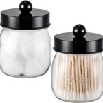Two black acrylic mason jar qtip holders with lids and labels, displayed on a bathroom counter.