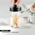 Two black acrylic mason jar qtip holders with lids and labels, displayed on a bathroom counter.