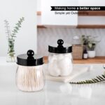 Two black acrylic mason jar qtip holders with lids and labels, displayed on a bathroom counter.